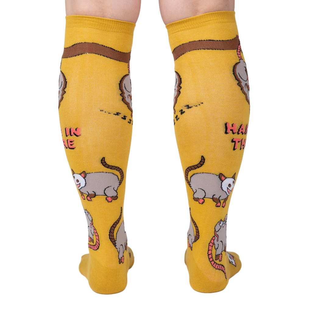 Rear view of mustard yellow knee-high socks showcasing the full possum pattern.