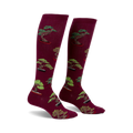 Pair of burgundy knee-high socks with a repeating pattern of green bonsai trees in terracotta pots.
