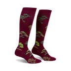 Pair of burgundy knee-high socks with a repeating pattern of green bonsai trees in terracotta pots.