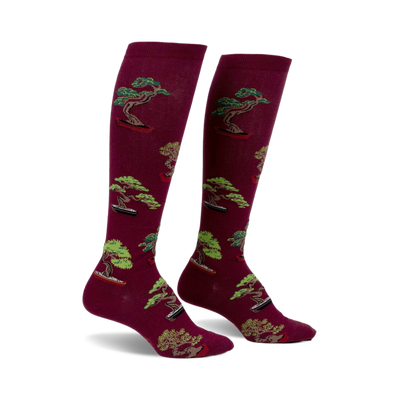 Pair of burgundy knee-high socks with a repeating pattern of green bonsai trees in terracotta pots.
