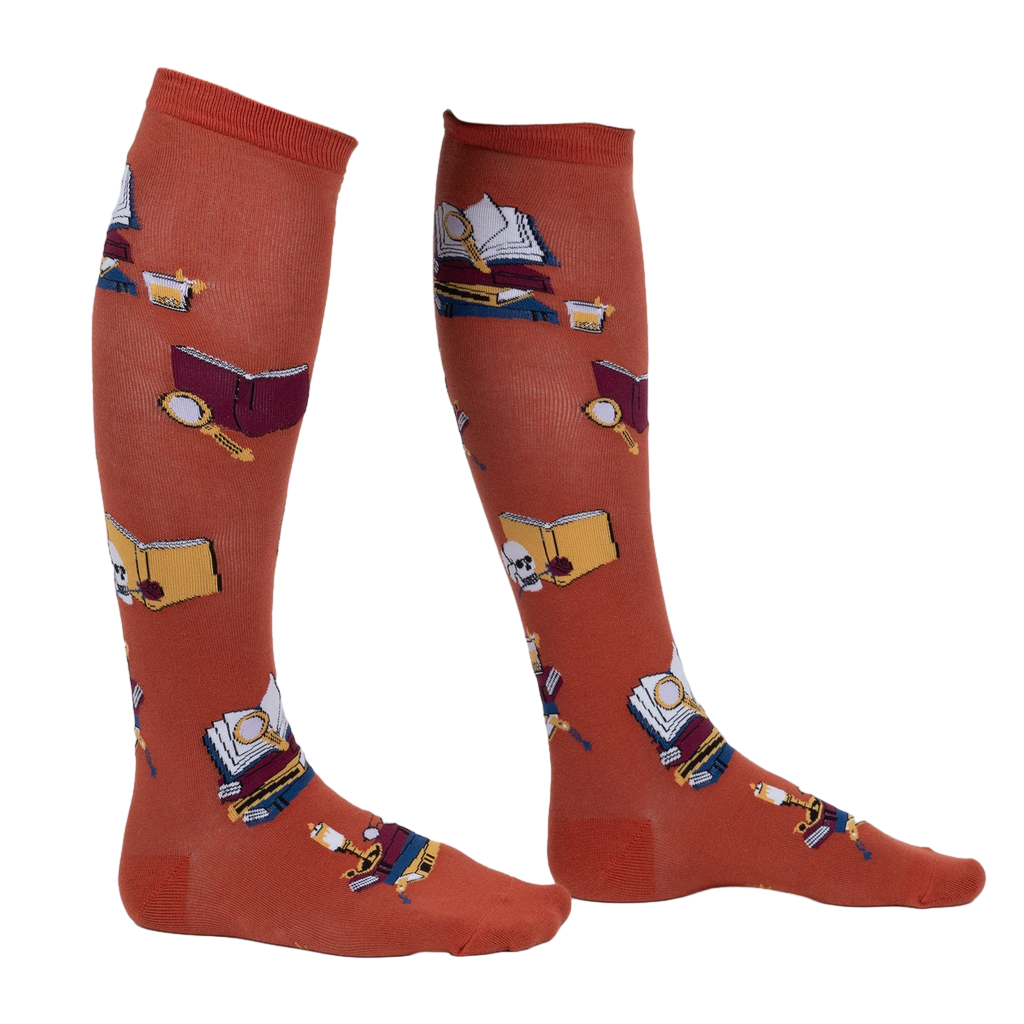 Lifestyle shot: Person wearing burnt orange True Crime knee-high socks.
