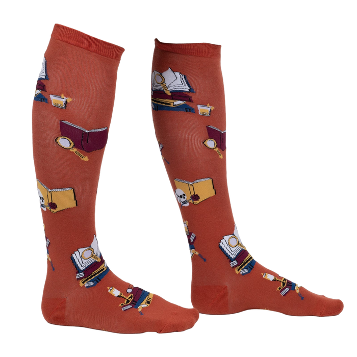 Lifestyle shot: Person wearing burnt orange True Crime knee-high socks.