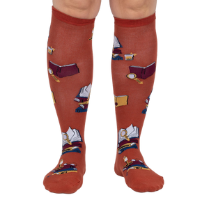 Front view: Pair of burnt orange True Crime knee-high socks on a light grey background.