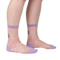 Lifestyle shot showing 'Wrapped in a Bow' socks on a model's legs, highlighting the fit and style.