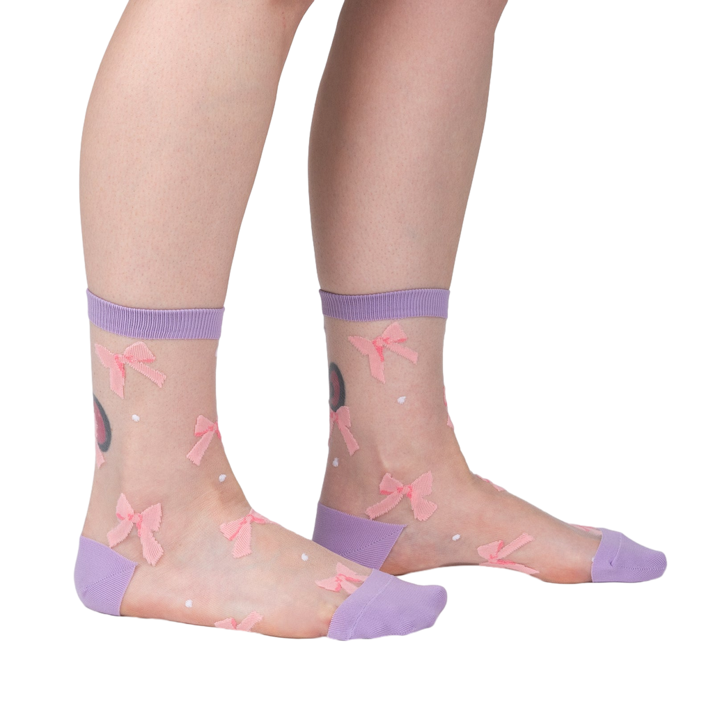 Lifestyle shot showing 'Wrapped in a Bow' socks on a model's legs, highlighting the fit and style.