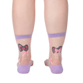 Rear view of the 'Wrapped in a Bow' socks on a model's legs showcasing the sock's design and fit from behind.