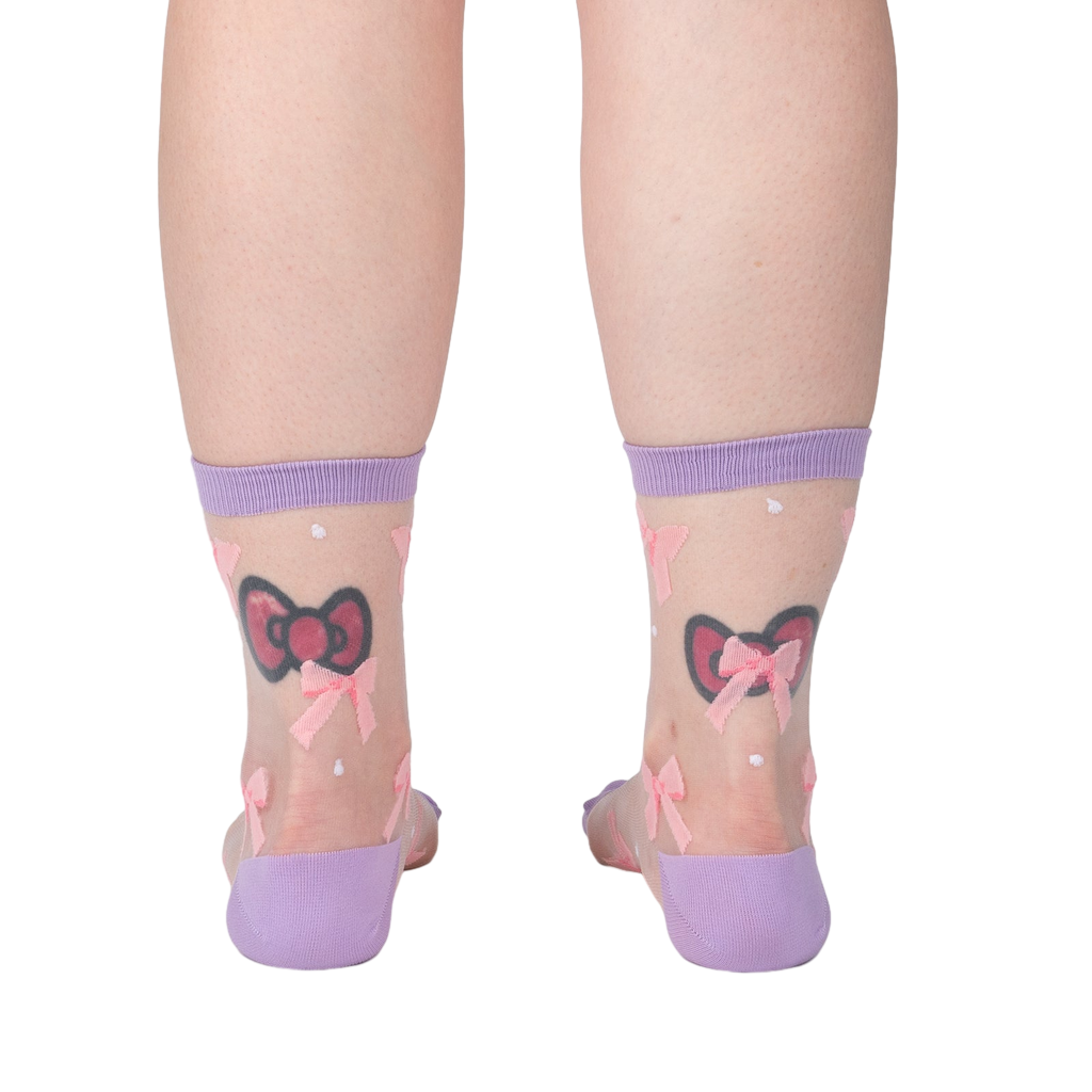 Rear view of the 'Wrapped in a Bow' socks on a model's legs showcasing the sock's design and fit from behind.