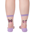 Rear view of the 'Wrapped in a Bow' socks on a model's legs showcasing the sock's design and fit from behind.
