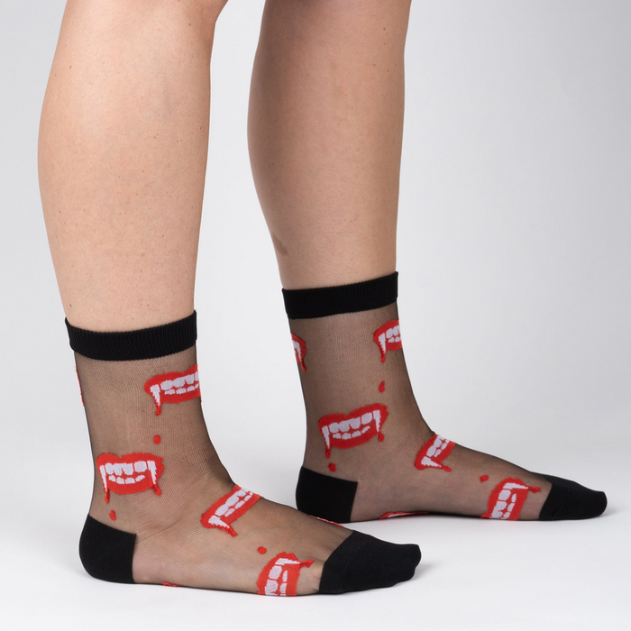 Lifestyle photo showing 'Bite Me' socks on a person's legs, showcasing the fit and design.