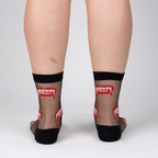 Rear view of model wearing 'Bite Me' socks, highlighting the full design on the back of the socks.