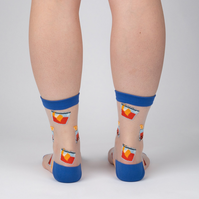 Rear view of the socks on a person's legs; showcases the sock's design and fit from the back.
