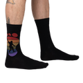 Lifestyle shot showing the 'Squatch and Learn' socks on a person's feet, showcasing the fit and design.