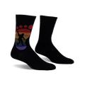 Black crew socks with a rainbow-colored Bigfoot footprint design.  The Bigfoot is silhouetted and holding up a peace sign.