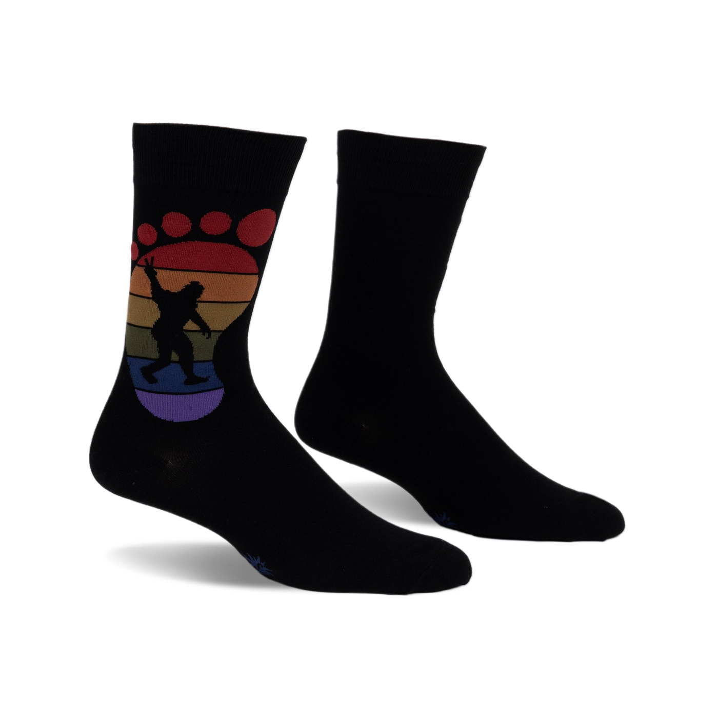Black crew socks with a rainbow-colored Bigfoot footprint design.  The Bigfoot is silhouetted and holding up a peace sign.