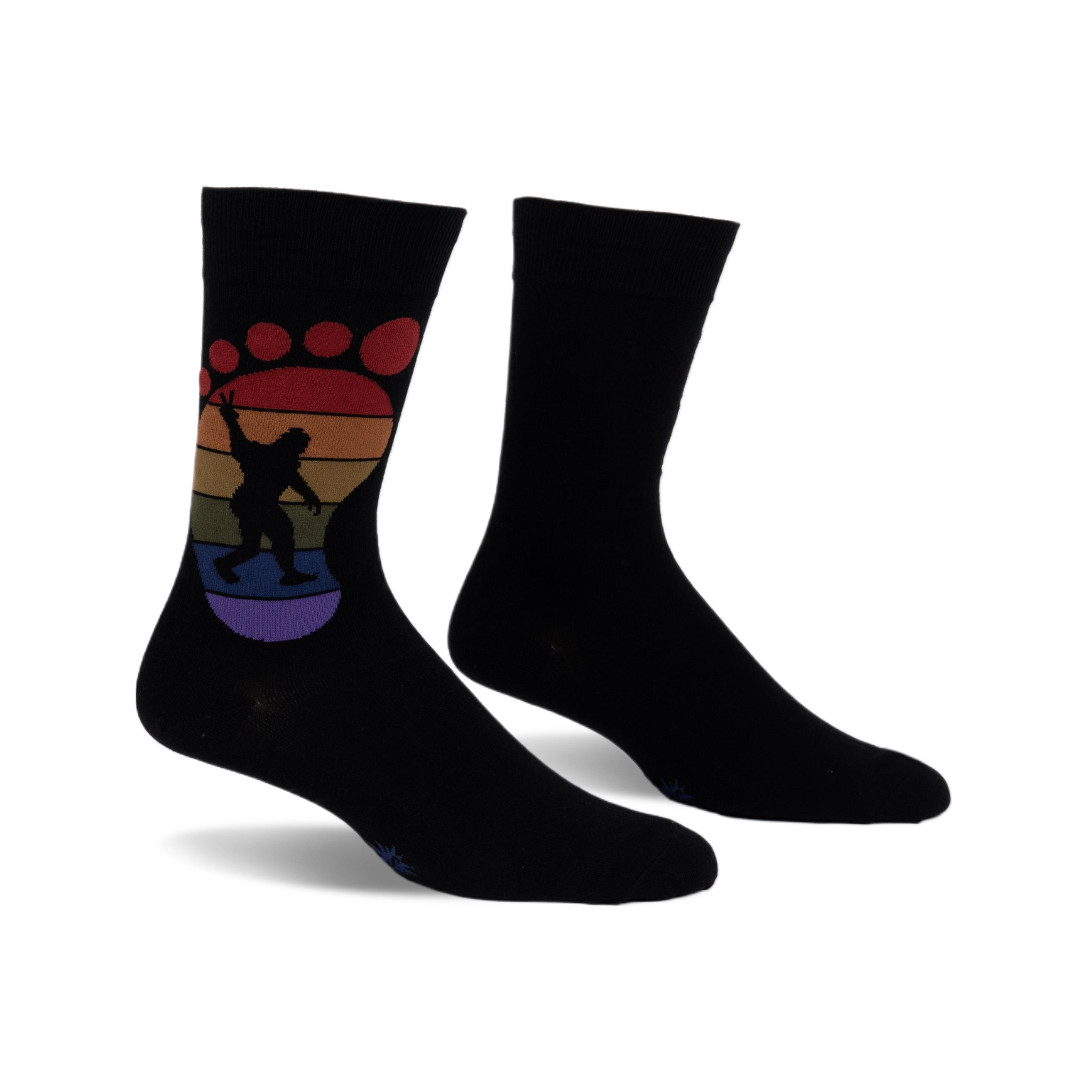 Black crew socks with a rainbow-colored Bigfoot footprint design.  The Bigfoot is silhouetted and holding up a peace sign.