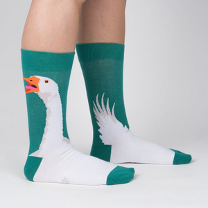 Lifestyle shot showing the socks on a person's legs. The socks are teal and white with a goose design.