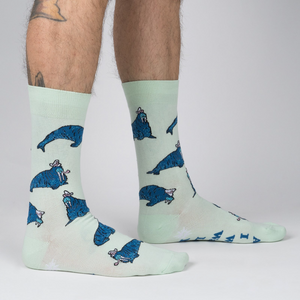 Lifestyle shot: Model's legs wearing the 'And I Will Walrus Love You' socks, showcasing fit and style.