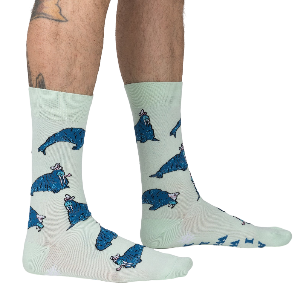Lifestyle shot: Model's legs wearing the 'And I Will Walrus Love You' socks, showcasing fit and style.
