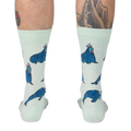 Rear view of model's legs showing the full sock design, emphasizing the walrus pattern.