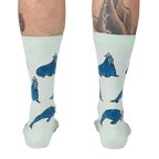 Rear view of model's legs showing the full sock design, emphasizing the walrus pattern.