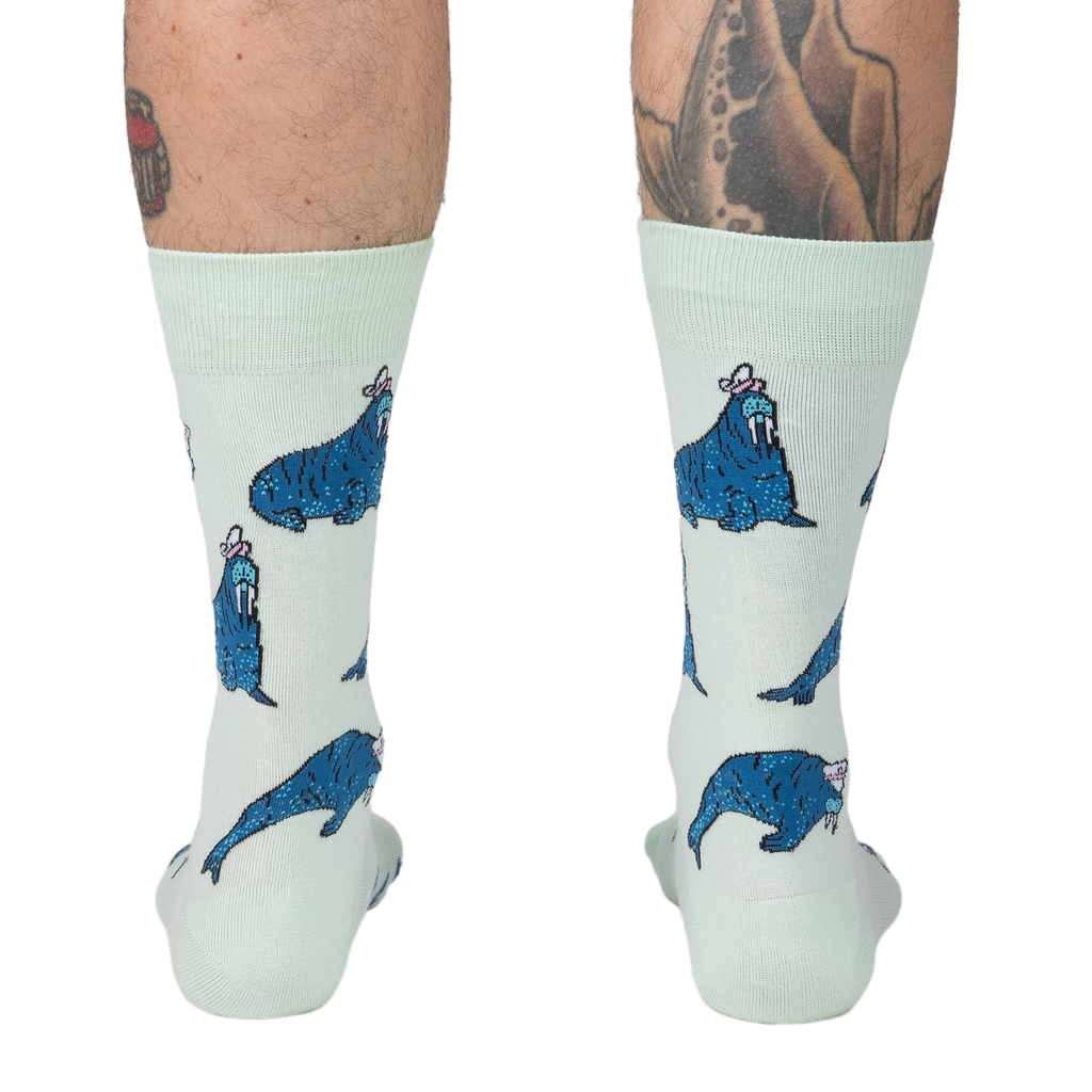Rear view of model's legs showing the full sock design, emphasizing the walrus pattern.