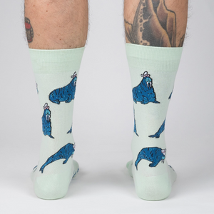 Rear view of model's legs showing the full sock design, emphasizing the walrus pattern.