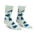 Pair of crew socks. Mint green background with repeating pattern of blue walruses wearing pink hats.