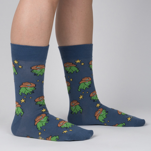 Lifestyle shot of a person wearing 'Yee Frog!' socks, showing how they look when worn.