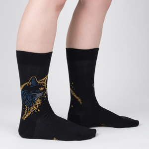 Lifestyle shot showcasing Night Cat socks on a model's legs, highlighting the sock's fit and design.