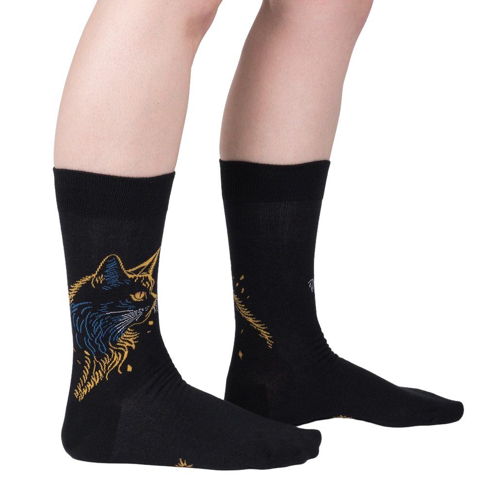 Lifestyle shot showcasing Night Cat socks on a model's legs, highlighting the sock's fit and design.