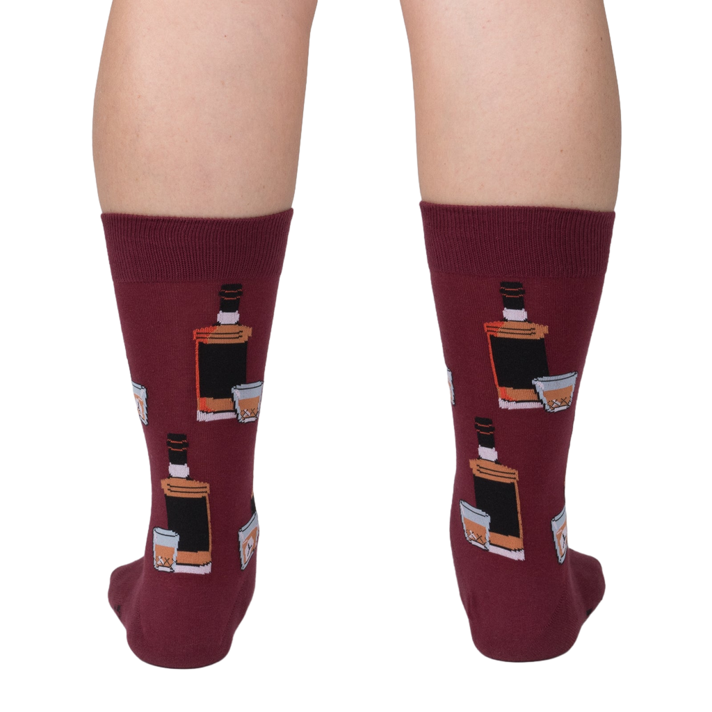 Rear view of the Whiskey Business socks on a person's legs.  Close up of the sock design on a burgundy background.