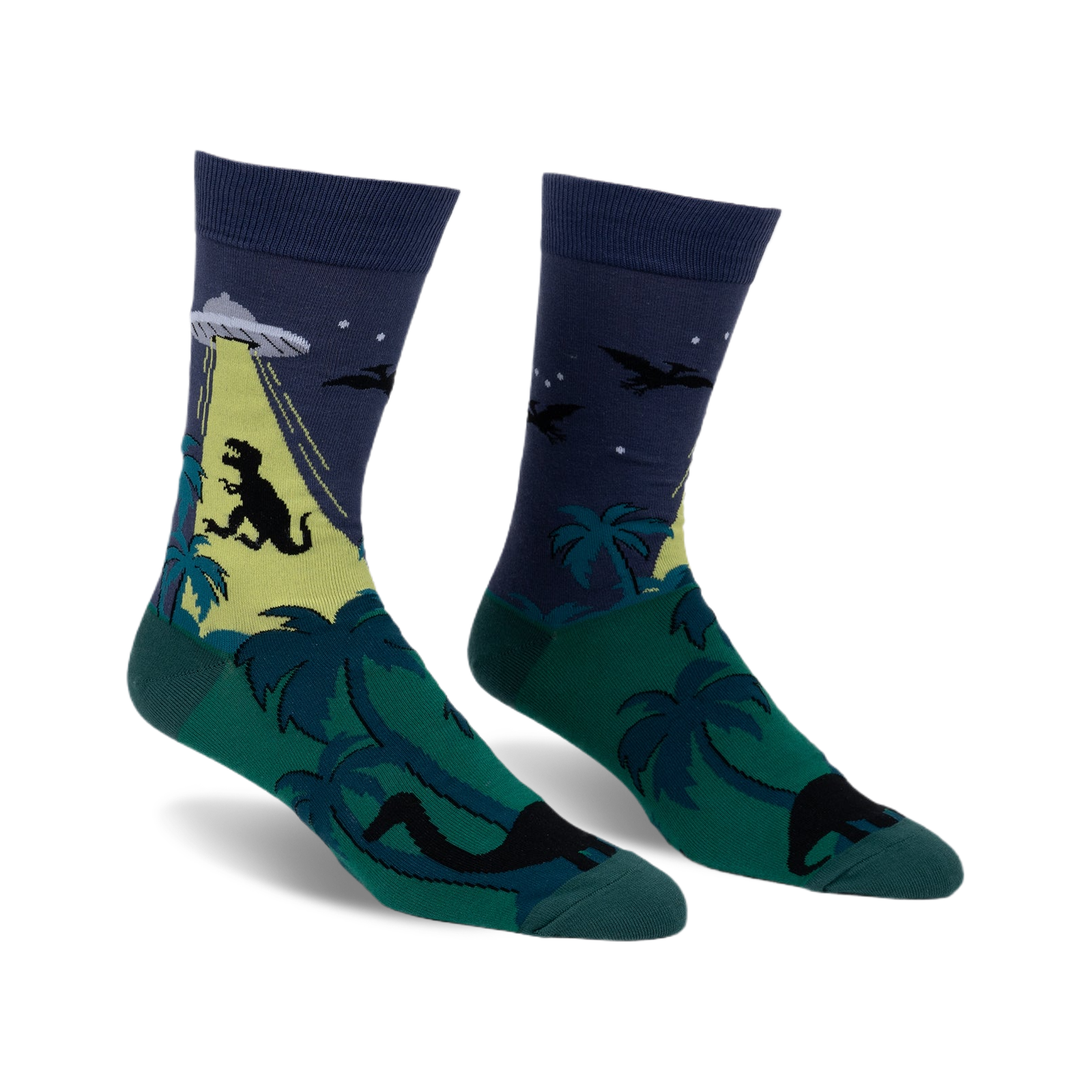 Crew socks in dark blue, green, and yellow. The design features a T-Rex, UFO, palm trees, and pterodactyls.