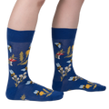 Lifestyle shot of 'Let it Bee' socks on a person's legs, showcasing the design and fit.