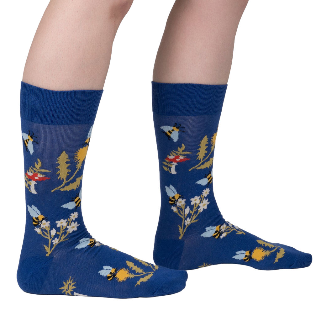 Lifestyle shot of 'Let it Bee' socks on a person's legs, showcasing the design and fit.