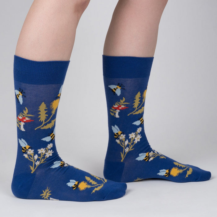 Lifestyle shot of 'Let it Bee' socks on a person's legs, showcasing the design and fit.