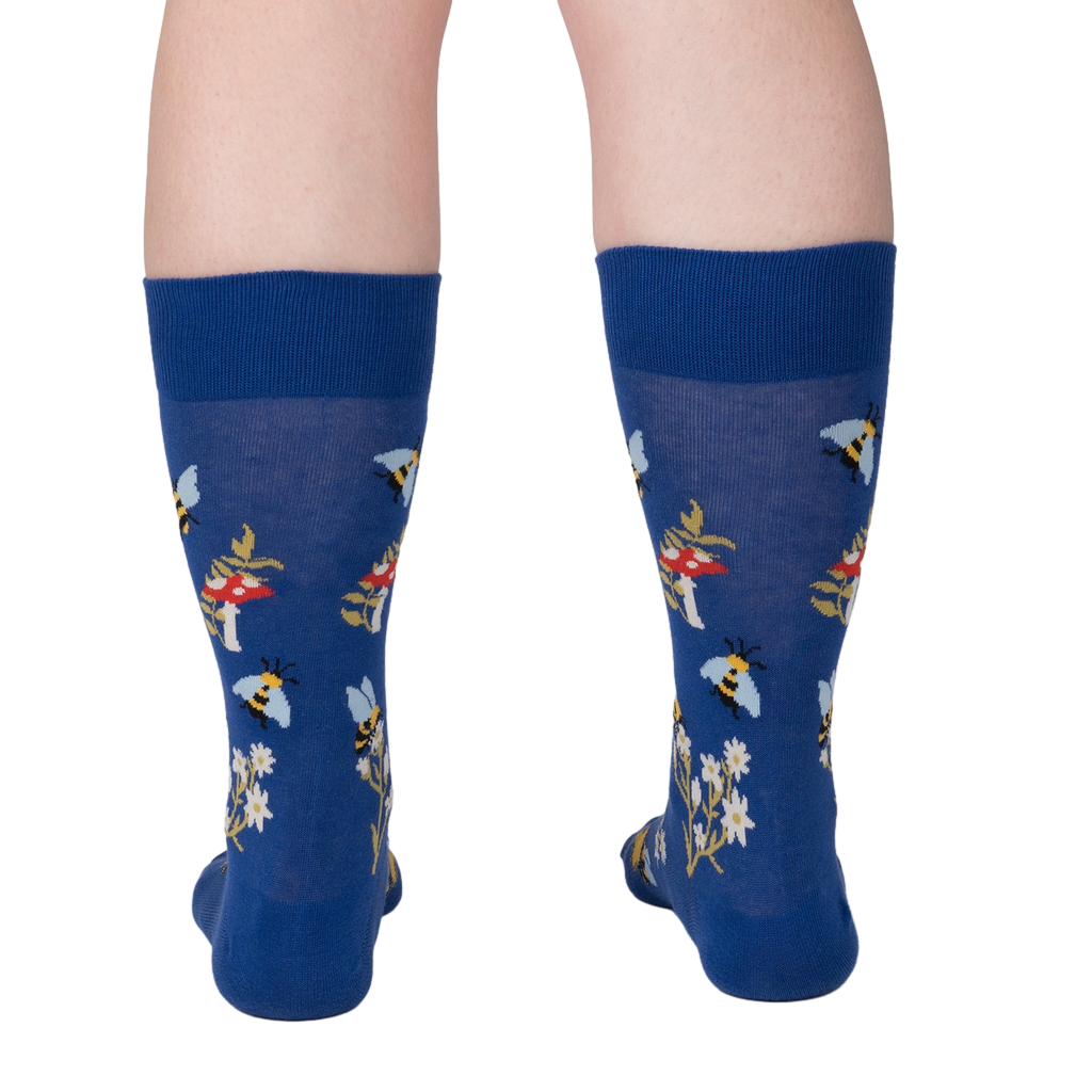 Rear view of 'Let it Bee' socks on a person's legs.  Shows the back of the sock design.