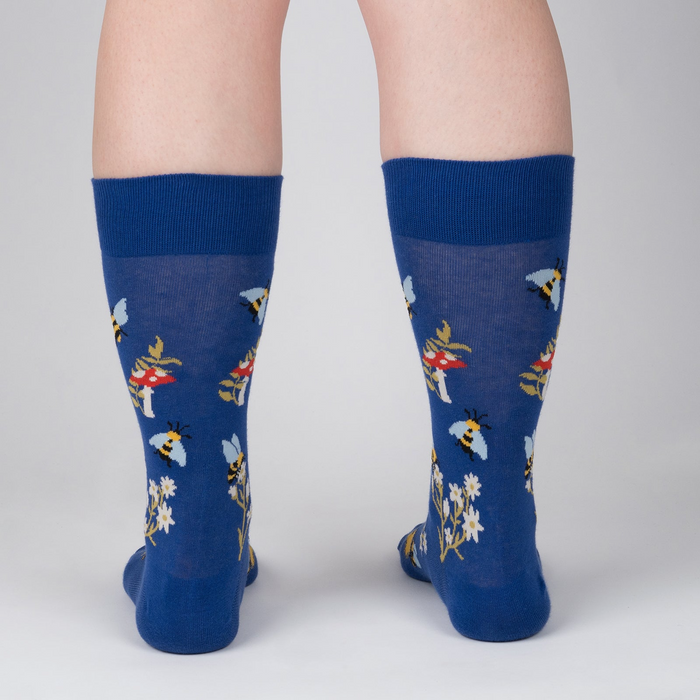 Rear view of 'Let it Bee' socks on a person's legs.  Shows the back of the sock design.