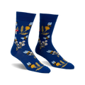 Pair of blue crew socks with whimsical bee, flower, and mushroom design.  Features yellow, white, and red accents.