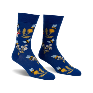 Pair of blue crew socks with whimsical bee, flower, and mushroom design.  Features yellow, white, and red accents.