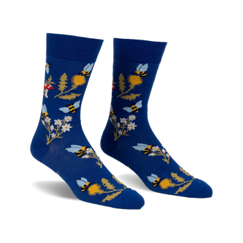 Pair of blue crew socks with whimsical bee, flower, and mushroom design.  Features yellow, white, and red accents.