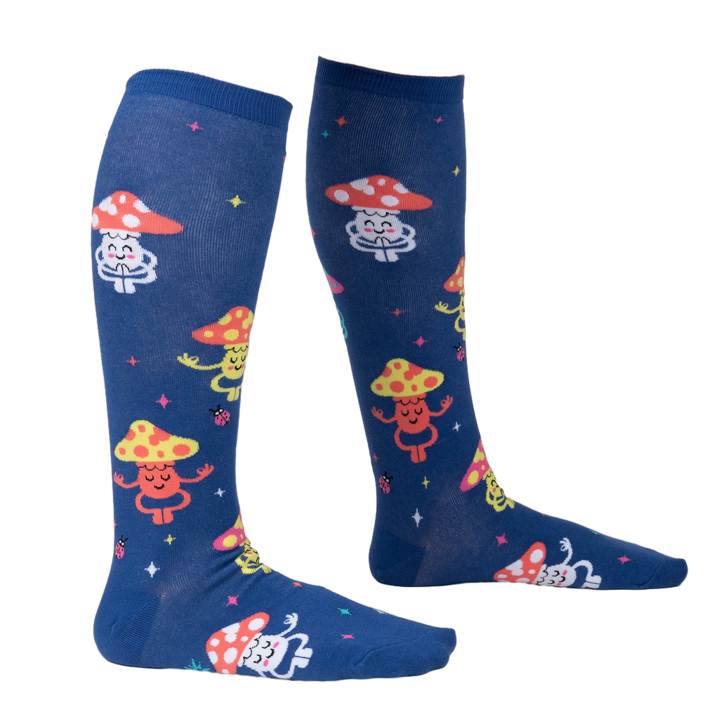 Lifestyle shot showing the socks on a person's legs.  The socks are navy blue with a fun mushroom pattern.