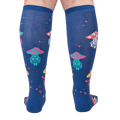 Rear view of a person wearing the navy blue knee-high socks with meditating mushrooms.