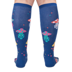 Rear view of a person wearing the navy blue knee-high socks with meditating mushrooms.