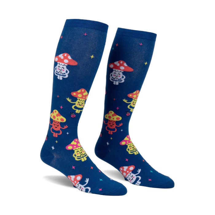 Pair of navy blue knee-high socks with a whimsical pattern of meditating mushrooms in various colors and tiny ladybugs. 