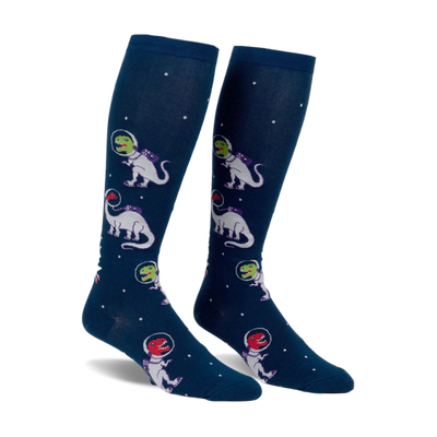 A pair of navy blue knee-high socks with a repeating pattern of white dinosaurs in space suits and small white dots.