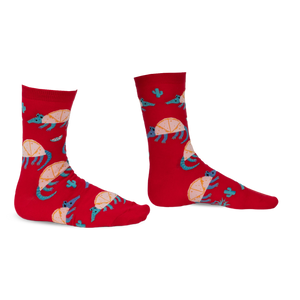 Pair of red crew socks featuring an armadillo design, cacti, and teal accents. Fun and quirky!