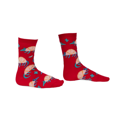 Pair of red crew socks featuring an armadillo design, cacti, and teal accents. Fun and quirky!