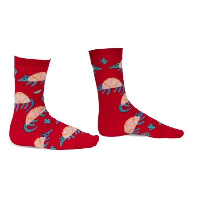 Pair of red crew socks featuring an armadillo design, cacti, and teal accents. Fun and quirky!