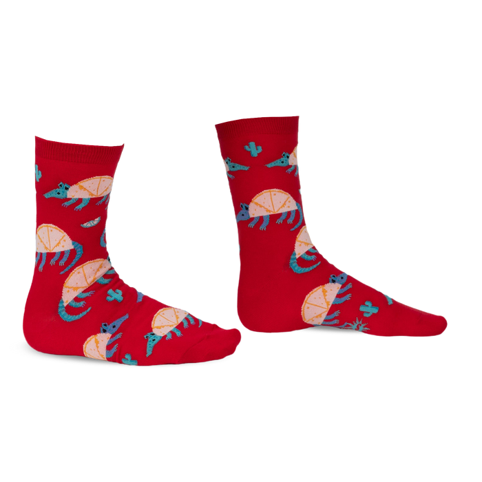 Pair of red crew socks featuring an armadillo design, cacti, and teal accents. Fun and quirky!