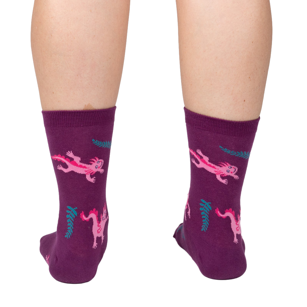 Back view of a person wearing Relaxolotl socks, showcasing the axolotl and fern pattern.